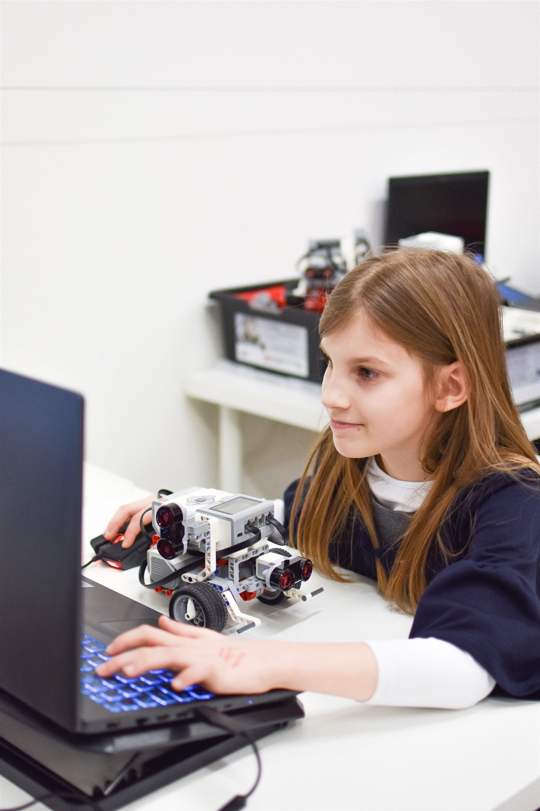 A student programming and testing a sensor-based LEGO robot